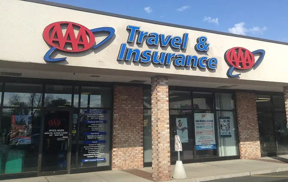 Travel and insurance office storefront with AAA logo in the UK.