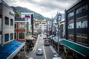 Hakone street view with shops and Mount Fuji in the distance.
