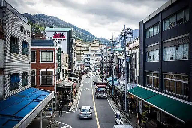Hakone street view with shops and Mount Fuji in the distance.