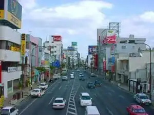 Tokyo street scene with shops and cars in Japan.