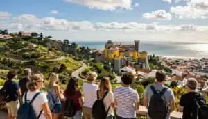 Exploring Lisbon's scenic outskirts with a group of travellers overlooking the city and coastline.